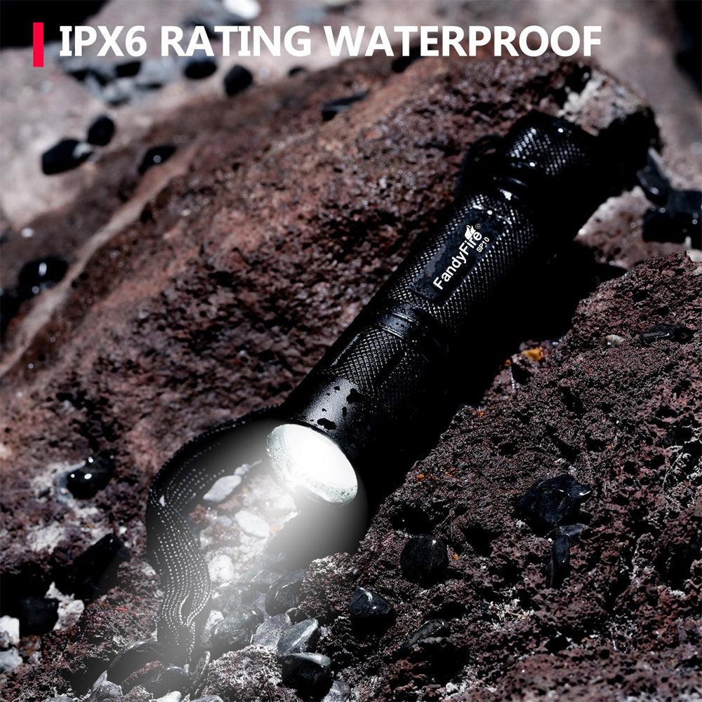 Waterproof FandyFire flashlight with IPX6 rating shining on wet rocks outdoors