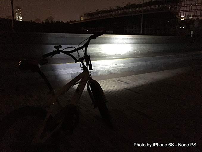 Bicycle in the dark with bright bike headlight illuminating steps outdoors at night
